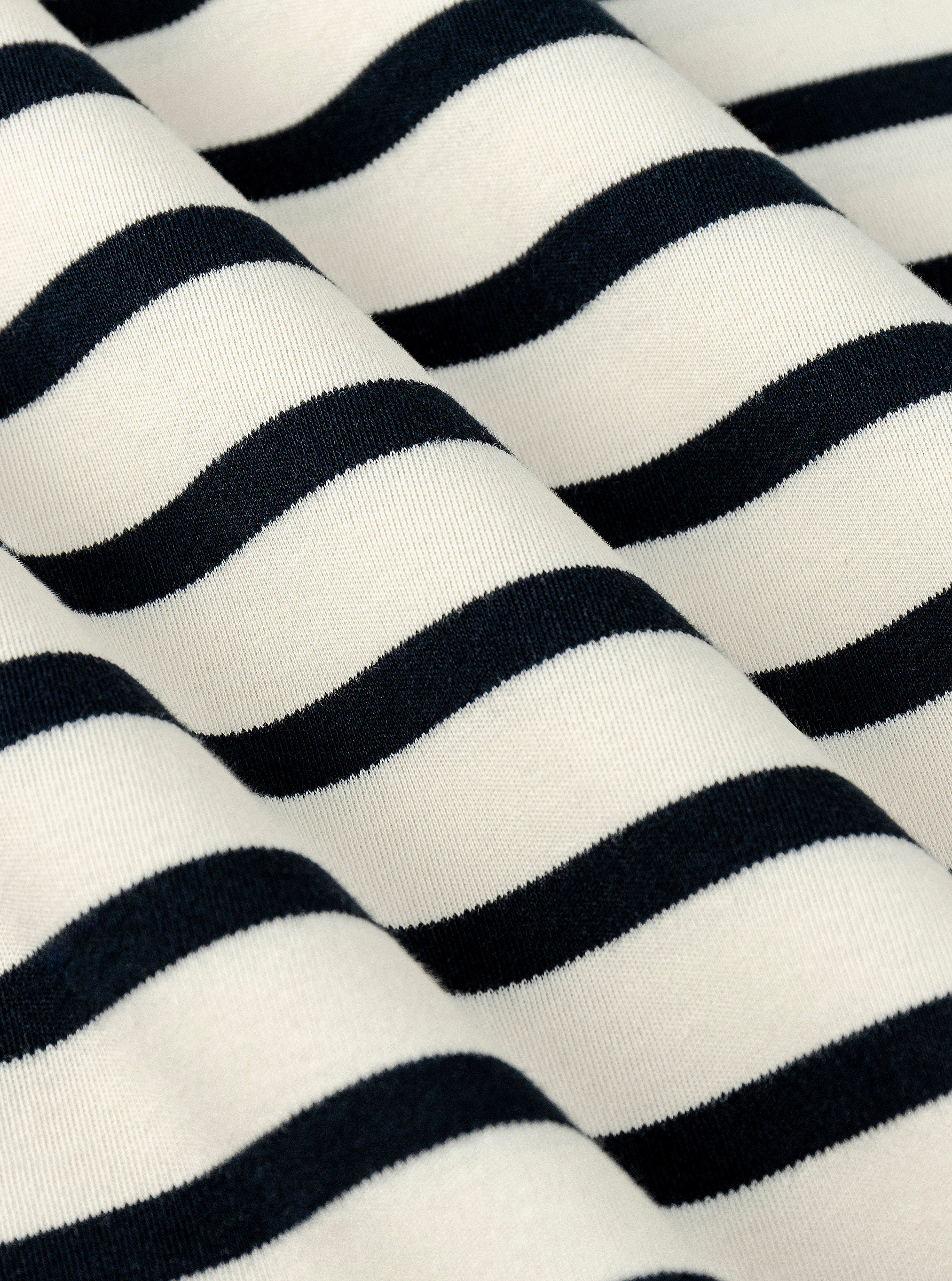 Stripe White/Navy|Black and white striped t-shirt on a light gray background|Stripe White/Navy
